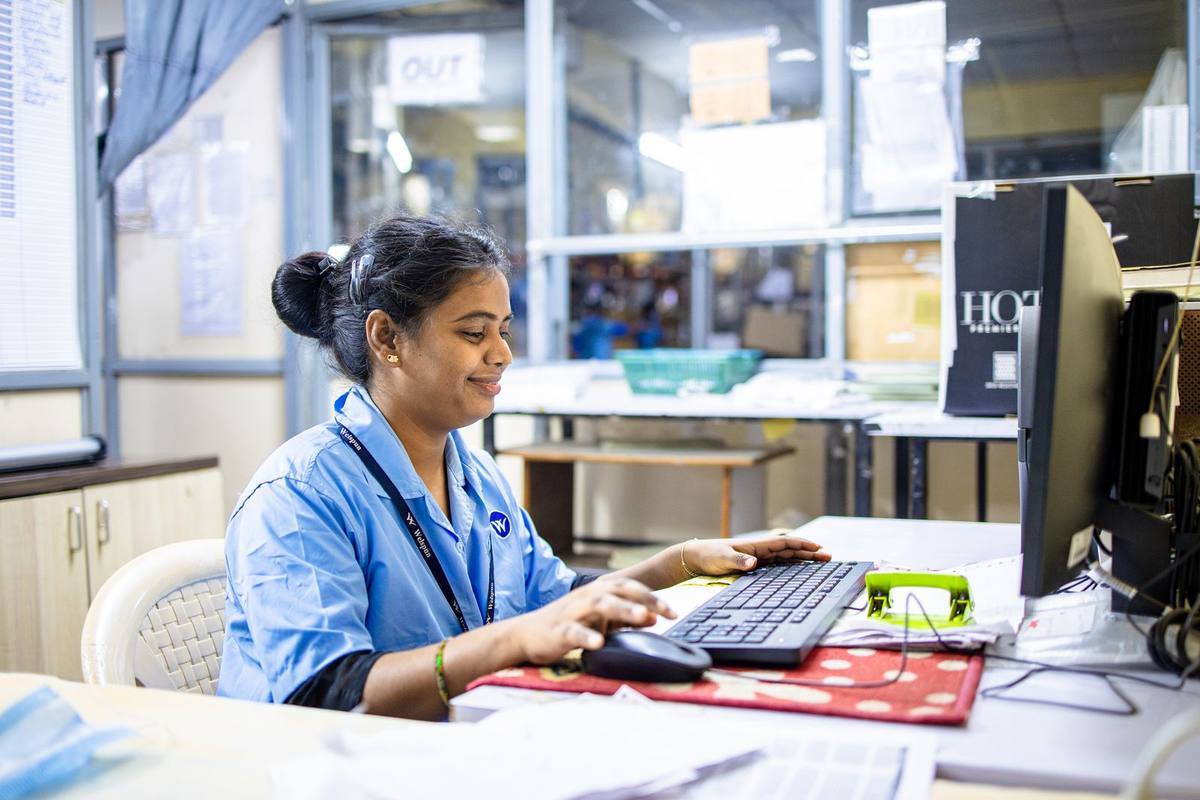A woman working at a computer in a workshop office