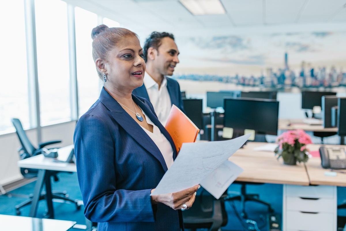 Colleagues in an Indian office discussing a document